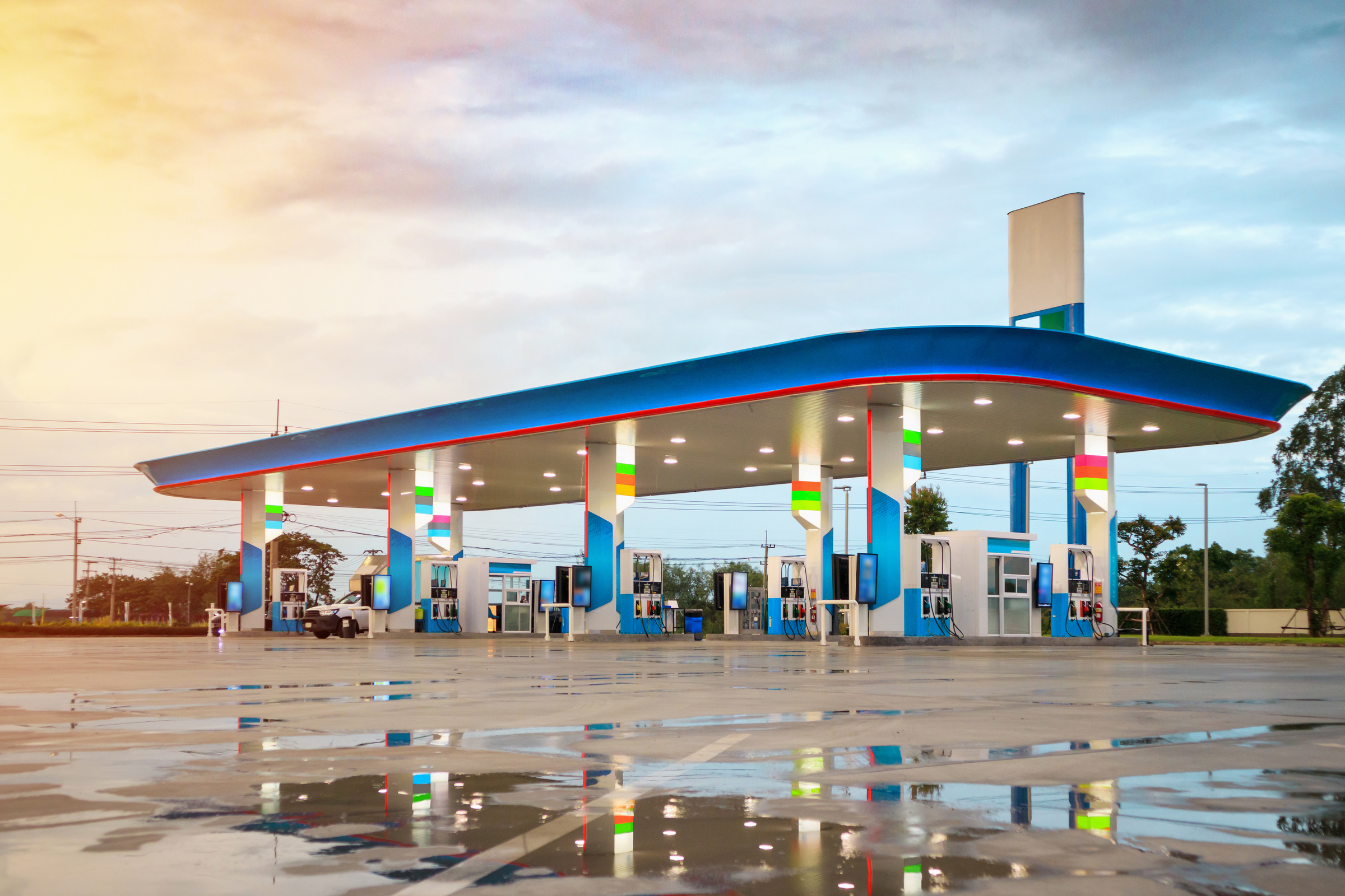 Gas fuel station with clouds and blue sky at sunset